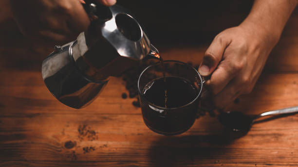 istock Barista pouring coffee from moka pot coffee maker. 1331884655