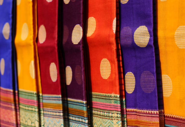 view of Indian woman fashion wear sarees or saris in retail display of a shop Close-up view of Indian woman fashion wear sarees or saris in retail display of a shop sari stock pictures, royalty-free photos & images