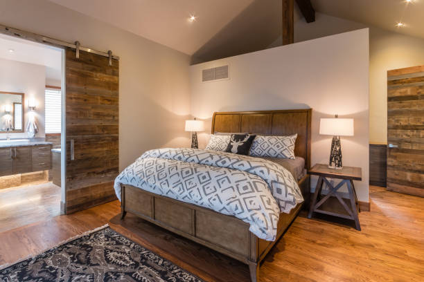 istock Master bedroom with hardwood flooring and half wall behind bed 1331891553