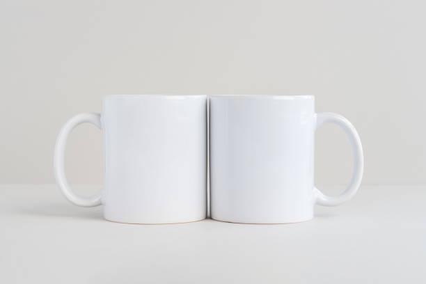 Two white mugs on light gray background, mockup