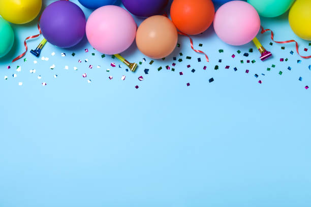 istock Flat lay composition with balloons and confetti on light blue background, space for text. Birthday decor 1331899754