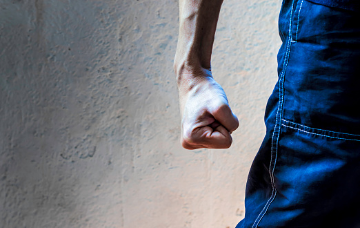 man closing his hand tightly. Clenched fist. Hand gesture. Fight, strength and determination concept.
