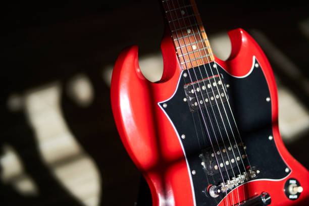 istock Electric guitar illuminated with light coming in through the window at dawn 1331901249