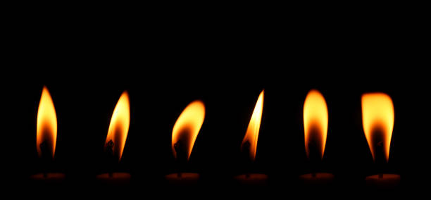 istock candle flame is burning At night at close range 1331902543