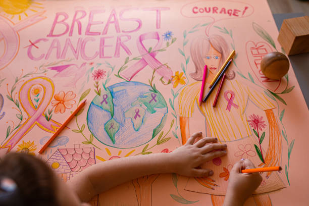 creative and responsible girl drawing the breast cancer awareness poster - community outreach connection child paper imagens e fotografias de stock