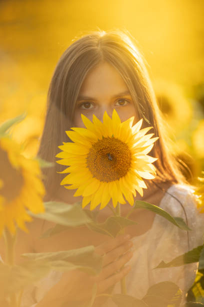 istock Young woman in sunflower 1331904207