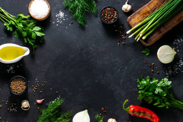 istock Fresh herbs, spices, peppers, dill, parsley on a black background. Place for text, culinary concept. Background for menu, recipe. 1331905992