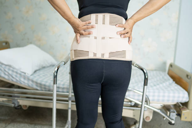 istock Asian lady patient wearing back pain support belt for orthopedic lumbar with walker. 1331908505