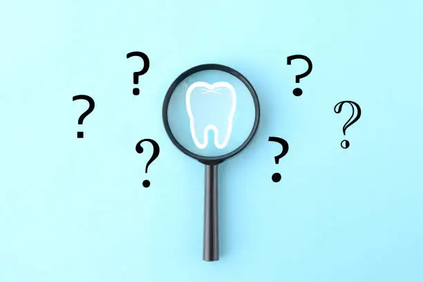 Photo of Qeustion about teeth conditon images, magnifying glass and tooth illustration