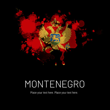 Flag of Montenegro ink splat on black background. Splatter grunge effect. Copy space. Solid background.