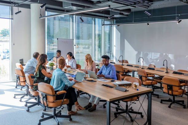 istock Photo of a large office space with people working on computers 1331917315