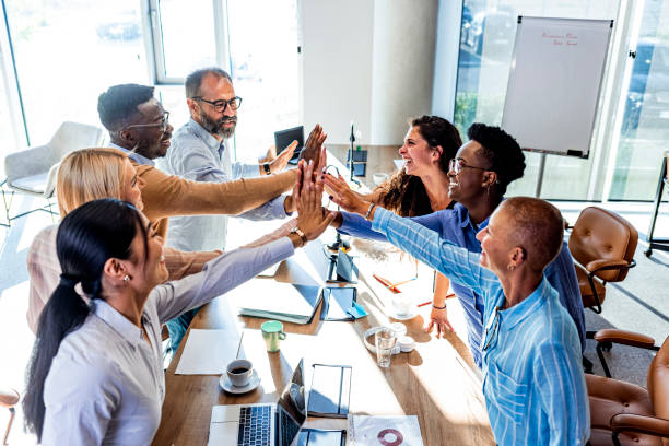 istock Large group of business colleagues holding their hands in unity. 1331917546