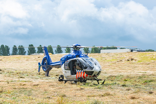 Helicopter Eurocopter - EC135 of the Dutch Police Aviation Service fitted with camera's for surveillance. The Helicopter landed in a field after taking pictures of the scene of an accident at the N50 highway near Kampen.