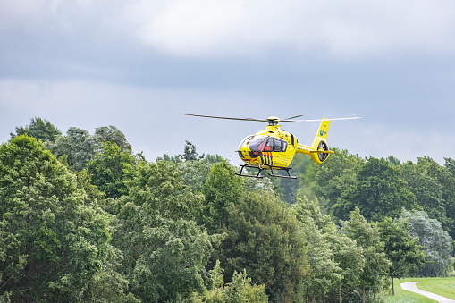 Medical helicopters on the scene of a severe accident on the N50 road near Kampen in Overijssel. The ANWB Medical Air Assistance transports medical personal for assisting at an accident site. The helicopter is an Airbus Helicopters H135 with registration PH-DOC.