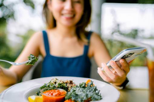 Young Asian Woman Eating Green Salad , Vegan food At Restaurant