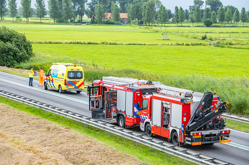 Scene of a severe car accident on the N50 road near Kampen in Overijssel, The Netherlands. Ambulance workers, firemen and police officers are taking car of the wounded occupants of the cars.