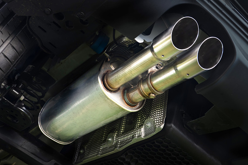 new exhaust muffler with double pipe from the modern sports car - view under the car
