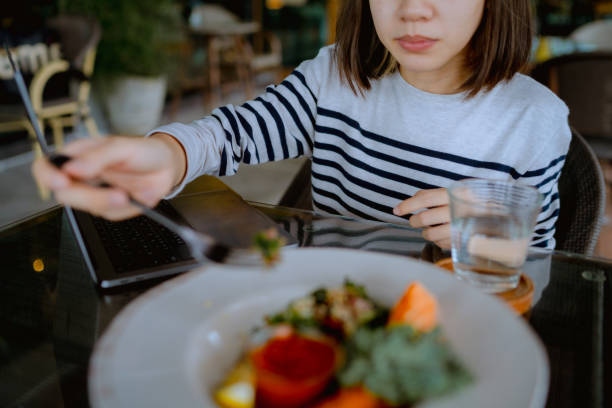 istock Busy woman working while eating breakfast at restaurants. 1331921450