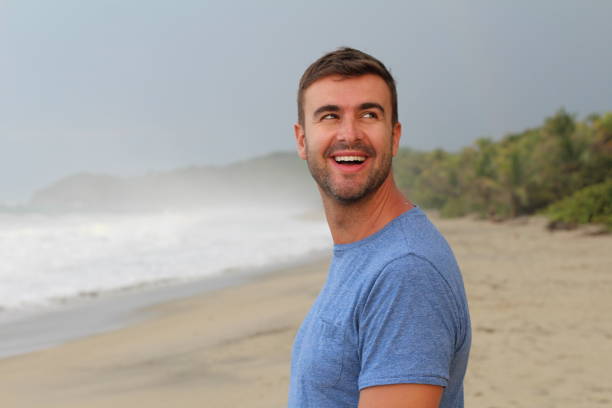 istock Healthy guy smiling at the beach 1331923823