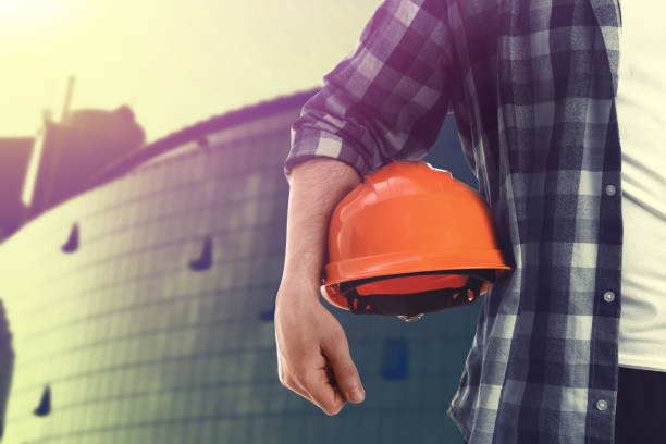 istock Man with orange hard hat at construction site, closeup. Space for text 1331923941