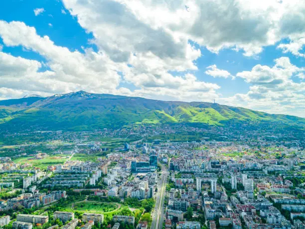 Photo of Wide drone shot of Vitosha mountain and busy traffic road in Sofia, Bulgaria. Bulgarian (Общ план на Витоша планина и бул.България)