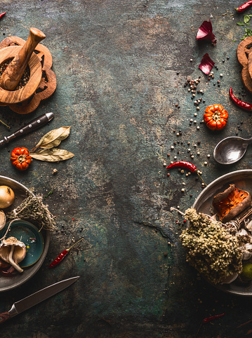 Food background with herbs and spices, top view. Frame. Dried seasoning for tasty food cooking