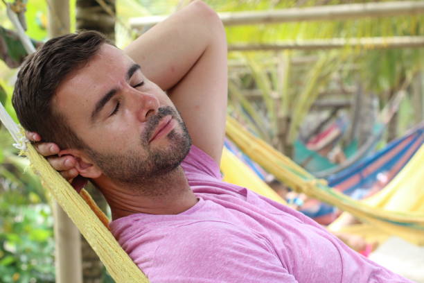 istock Guy enjoying a hammock in topical island 1331926397