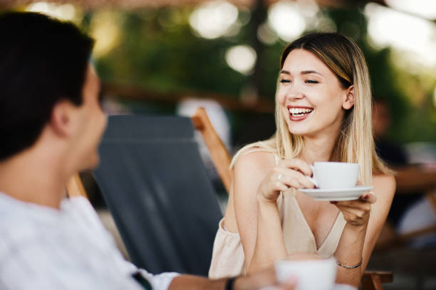 istock Woman and man drinking coffee in a summer cafe 1331926427