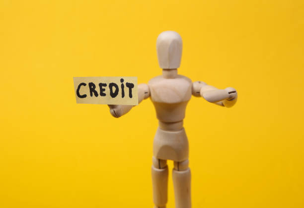 istock Text credit with wooden puppet figure on yellow background 1331926606