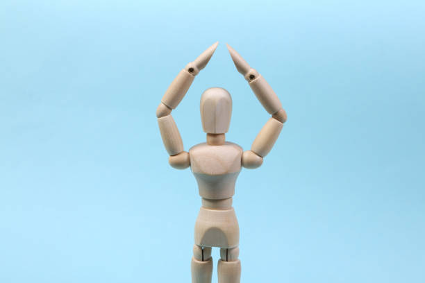 istock A wooden puppet holds arms above its head. Protection concept 1331926653