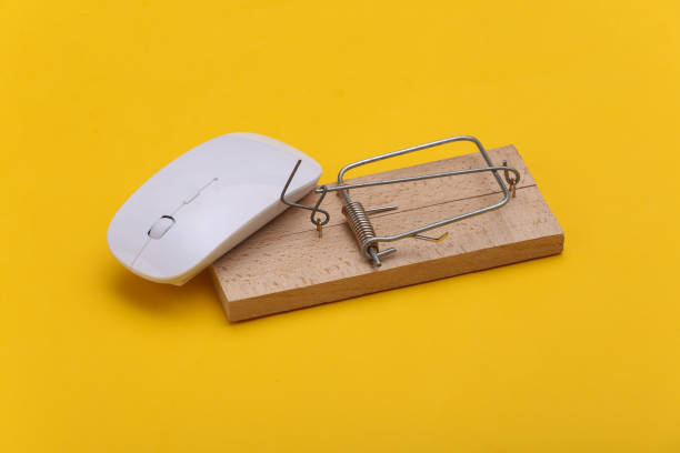 istock Mousetrap with pc mouse on a yellow background. Online trap 1331927333