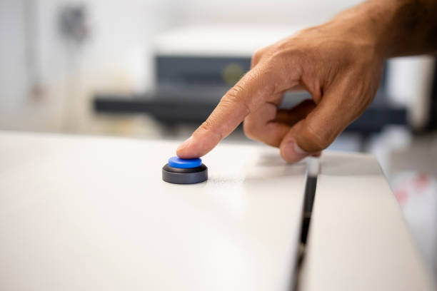 istock Close up view of worker's hand pressing button on industrial machine. 1331928624