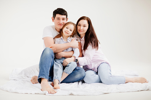 Happy loving family. Mother, father and children daughters on white background.