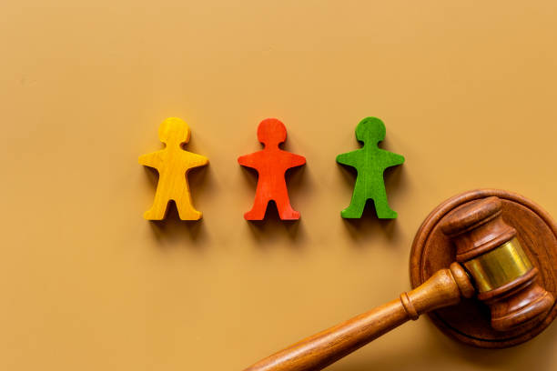 istock Mediator conflict resolving. Judge gavel with wooden figures arbitrator between opponents 1331933139