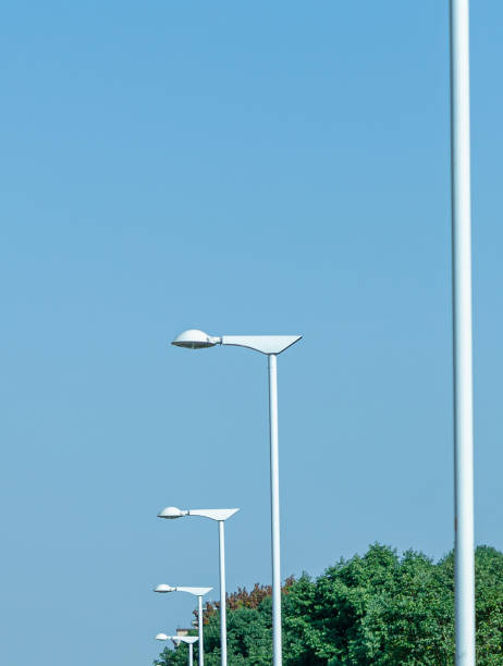 istock Street lamps and trees under a blue sky 1331933883
