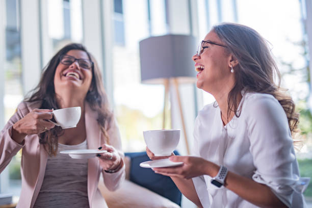 istock Two happy female coworkers drinking coffee 1331935778