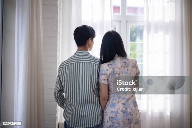 Young Asian Couple Looking Through Window Stock Photo - Download Image Now - Japanese Ethnicity, Rear View, Couple - Relationship