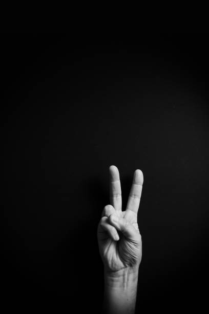 istock B&W image of hand demonstrating ASL sign language letter V with empty copy space 1331940450