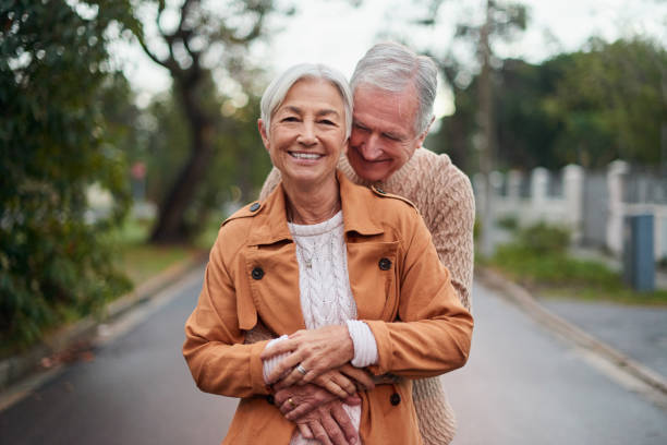 Shot of a mature couple taking a sunset stroll stock photo
