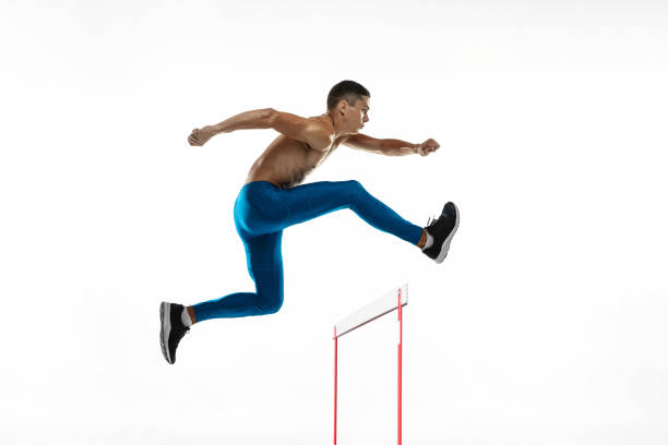 istock Steeplechase. Young male athlete, runner running, jumping isolated on white studio background. Muscular, sportive man. Concept of sport, healthy lifestyle 1331942134
