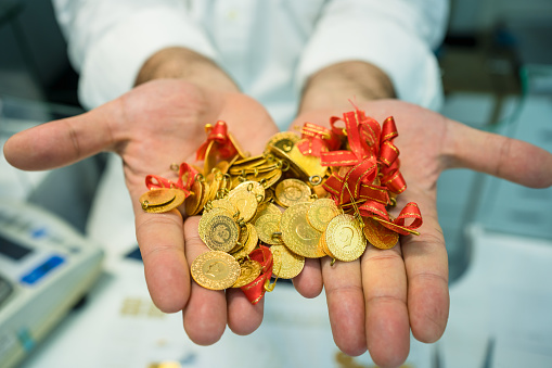 Man with gold coins in the hand