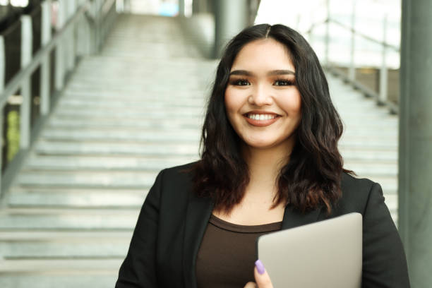 istock Asian Businesswoman Holding Computer 1331943905