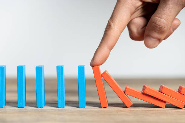 istock Finger holding red domino 1331944920