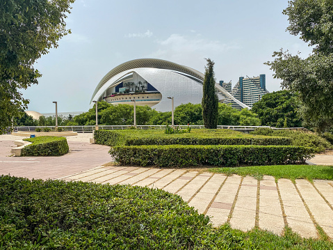 Valencia, Spain - July 23, 2021: View of the Palau de les Arts Reina Sofia and its surrounding gardens in the City of the Arts and the Sciences. This is an opera house opened in 2005