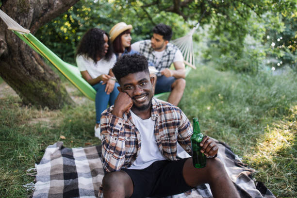 istock Relaxed black man having summer picnic with friends 1331948052