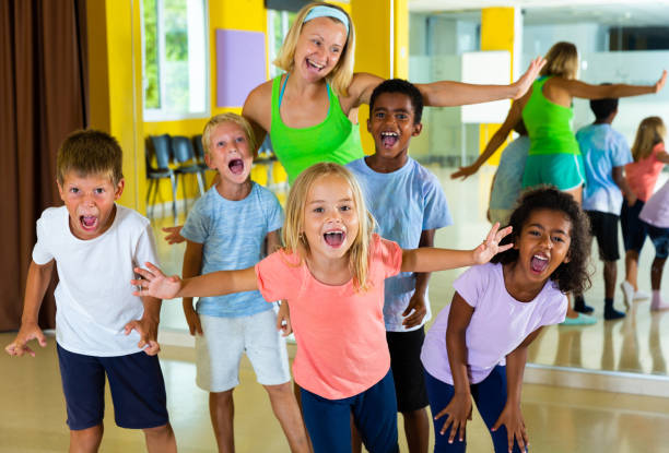 istock Cheerful children with trainer in choreography class 1331950011