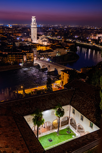 Aerial view of Verona historical city centre, Ponte Pietra bridge across Adige river, Cathedral, Duomo - Beautiful cityscape panoramic view of the city center along Adige river at sunset in Verona