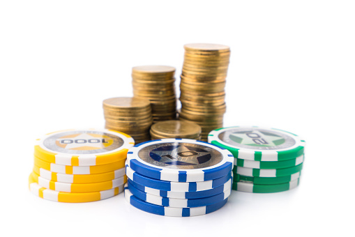Casino chips and money golden coins stack for games like poker, card and blackjack, roulette. Betting club and gamble