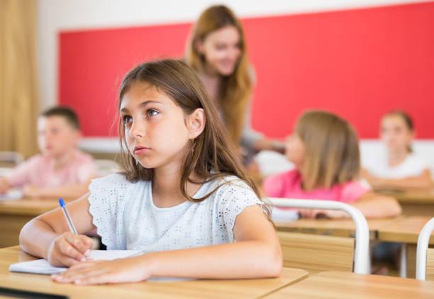 istock Children sitting in classroom 1331951998
