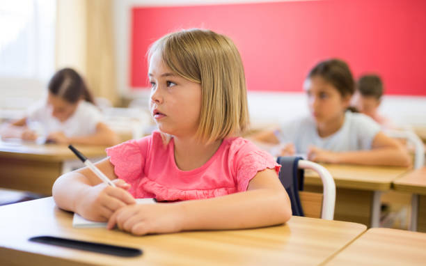 istock Girl sitting in classroom 1331952010